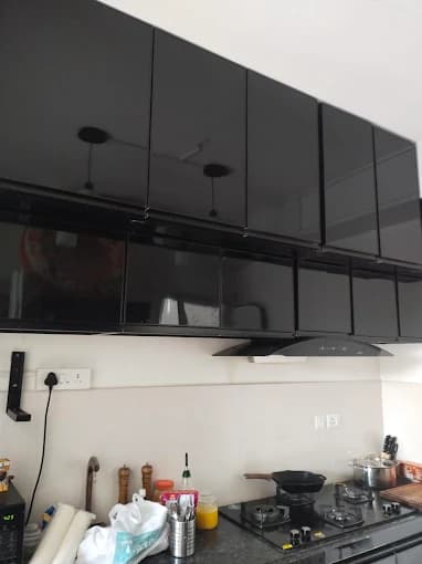 Modular kitchen with glossy overhead units